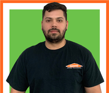 Victor, SERVPRO employee in uniform, cut out in front of white background